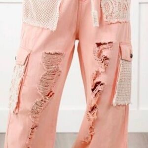 Creamy Pink Cargo Pants with Lace Accents and distressed front.